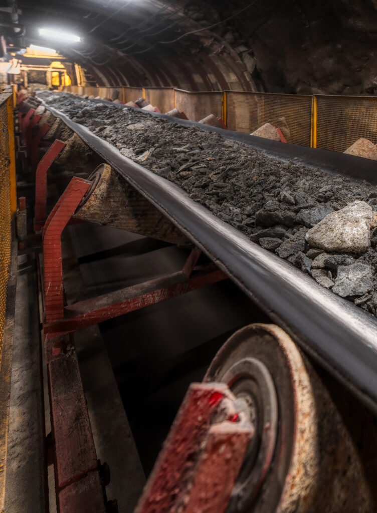 Underground mining conveyor belt system transporting bulk rock at Belt Fasteners site